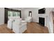 Cozy living room with fireplace, TV, hardwood floors, large windows, and comfortable seating at 7011 Pumpkinseed Dr, Johns Island, SC 29455