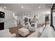 Spacious living room and kitchen with hardwood floors, white sofa, and open concept design at 7011 Pumpkinseed Dr, Johns Island, SC 29455