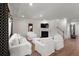 Bright living room featuring fireplace, TV, large window, hardwood floors, and ample seating at 7011 Pumpkinseed Dr, Johns Island, SC 29455