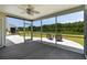 Covered back patio overlooking lush backyard and lake, perfect for relaxing and entertaining guests at 7011 Pumpkinseed Dr, Johns Island, SC 29455