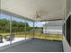 Screened patio featuring a ceiling fan and seating with backyard and lake views at 7011 Pumpkinseed Dr, Johns Island, SC 29455