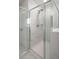 Modern bathroom shower featuring marble-patterned tiles, glass doors, and a contemporary shower head at 7011 Pumpkinseed Dr, Johns Island, SC 29455
