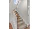 Carpeted staircase with white railing and wooden banister at 7011 Pumpkinseed Dr, Johns Island, SC 29455