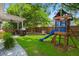 Lush backyard featuring a fire pit, outdoor grill, and a play set at 7030 Billberry St, Hanahan, SC 29410