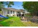 Large backyard featuring a fire pit, porch seating, and a playset at 7030 Billberry St, Hanahan, SC 29410