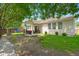 Expansive backyard view featuring a fire pit, covered porch, and playset at 7030 Billberry St, Hanahan, SC 29410