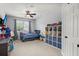 Cozy bedroom features a ceiling fan, large window, and lots of toy storage at 7030 Billberry St, Hanahan, SC 29410