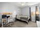 Comfortable bedroom with a ceiling fan, stylish desk, and a black metal frame bed at 7030 Billberry St, Hanahan, SC 29410