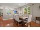 Bright dining room featuring hardwood floors, a dining table with chairs, and open to living area at 7030 Billberry St, Hanahan, SC 29410