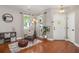 Inviting entryway with hardwood floors, a cozy chair, and stylish decor at 7030 Billberry St, Hanahan, SC 29410