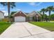 Charming brick home with an attached garage, well manicured lawn, and stately palm trees at 7030 Billberry St, Hanahan, SC 29410