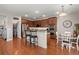 Open kitchen with stainless steel appliances, granite countertops, island with seating, and modern lighting at 7030 Billberry St, Hanahan, SC 29410