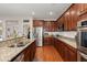 Modern kitchen with granite countertops, stainless steel appliances, and hardwood flooring at 7030 Billberry St, Hanahan, SC 29410