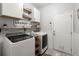 Functional laundry room with modern appliances, storage cabinets, and farmhouse style decor at 7030 Billberry St, Hanahan, SC 29410