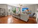 Bright living room with hardwood floors, large windows, and comfortable seating area at 7030 Billberry St, Hanahan, SC 29410