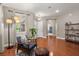 Inviting living room featuring hardwood floors, chair, natural light, and modern lighting at 7030 Billberry St, Hanahan, SC 29410