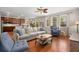 Open living room featuring hardwood floors, cozy furniture, and seamless transition to the kitchen at 7030 Billberry St, Hanahan, SC 29410