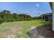 Large backyard with lawn and view of trees; house roof line visible at 7035 Pumpkinseed Dr, Johns Island, SC 29455