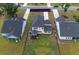 Aerial view of the backyard featuring a black fence, screened-in porch, and green lawn at 7035 Pumpkinseed Dr, Johns Island, SC 29455