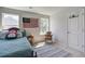Bedroom with two windows, plush pillows on the bed, and a basketball hoop on the door at 7035 Pumpkinseed Dr, Johns Island, SC 29455