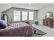 Spacious bedroom with ample natural light, a unique hanging chair, and stylish decor at 7035 Pumpkinseed Dr, Johns Island, SC 29455