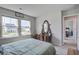 Comfortable bedroom featuring two large windows and a wood dresser with an oval mirror at 7035 Pumpkinseed Dr, Johns Island, SC 29455