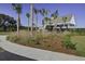 Clubhouse surrounded by palm trees and flower beds at 7035 Pumpkinseed Dr, Johns Island, SC 29455