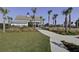 A walkway leads to the community clubhouse with palm trees and green grass at 7035 Pumpkinseed Dr, Johns Island, SC 29455