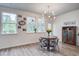 The dining area is filled with natural light and boasts stylish light fixtures, complemented by wood accents at 7035 Pumpkinseed Dr, Johns Island, SC 29455