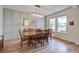 This dining room features beautiful natural lighting, hard wood floors, and a stylish light fixture at 7035 Pumpkinseed Dr, Johns Island, SC 29455