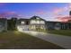 Charming two-story home boasts a two-car garage, long driveway, and inviting front porch at 7035 Pumpkinseed Dr, Johns Island, SC 29455