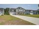 Charming two-story home boasts a two-car garage, long driveway, and inviting front porch at 7035 Pumpkinseed Dr, Johns Island, SC 29455