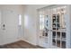 Bright foyer with wood floors leading to glass-paneled doors to an office at 7035 Pumpkinseed Dr, Johns Island, SC 29455