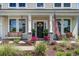Inviting front porch featuring a swing, seating, and well-manicured landscaping at 7035 Pumpkinseed Dr, Johns Island, SC 29455