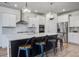 This modern kitchen features a large island with bar seating, stainless appliances, and pendant lighting at 7035 Pumpkinseed Dr, Johns Island, SC 29455