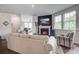 The living room features a fireplace, comfortable seating, and plenty of natural light from the surrounding windows at 7035 Pumpkinseed Dr, Johns Island, SC 29455
