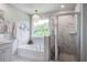 Clean bathroom with chandelier, tub, and shower combo at 7035 Pumpkinseed Dr, Johns Island, SC 29455