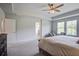 Large main bedroom with tray ceilings, ceiling fan and sitting area at 7035 Pumpkinseed Dr, Johns Island, SC 29455
