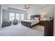 Bright main bedroom featuring a tray ceiling, sitting area and natural light at 7035 Pumpkinseed Dr, Johns Island, SC 29455