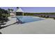 Sparkling pool with lakeside views and covered outdoor kitchen and lounge area for residents at 7035 Pumpkinseed Dr, Johns Island, SC 29455