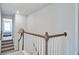 Interior shot of a carpeted staircase with white railings and wood accents, leading to the upper level at 7035 Pumpkinseed Dr, Johns Island, SC 29455