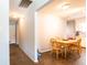 Bright dining area with a wooden table and chairs next to an open kitchen layout at 7621 Oldridge Rd, North Charleston, SC 29418