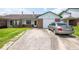 Charming single-story home featuring a brick facade, attached garage, and a well-maintained front yard at 7621 Oldridge Rd, North Charleston, SC 29418
