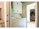 Laundry area with white washer and dryer and view into main bedroom at 7621 Oldridge Rd, North Charleston, SC 29418