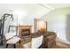 Comfortable living room with a cozy fireplace, brown sofa, and white and patterned chairs at 7621 Oldridge Rd, North Charleston, SC 29418