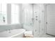 Modern bathroom with a walk-in shower, a soaking tub, and clean lines and white finishes at 770 Clay Field Trl, Summerville, SC 29485