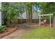 Lush backyard with mature trees, grassy areas, and a charming wooden swing bench, offering a tranquil outdoor retreat at 800 Heyward Cove Pl, Charleston, SC 29412