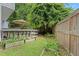 Private backyard with a wooden deck, mature trees and garden boxes at 800 Heyward Cove Pl, Charleston, SC 29412