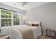Cozy bedroom with natural light from a large window and comfortable furniture at 800 Heyward Cove Pl, Charleston, SC 29412