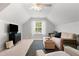 Bright bonus room featuring neutral carpeting, comfortable seating arrangement, and a modern ceiling fan at 800 Heyward Cove Pl, Charleston, SC 29412